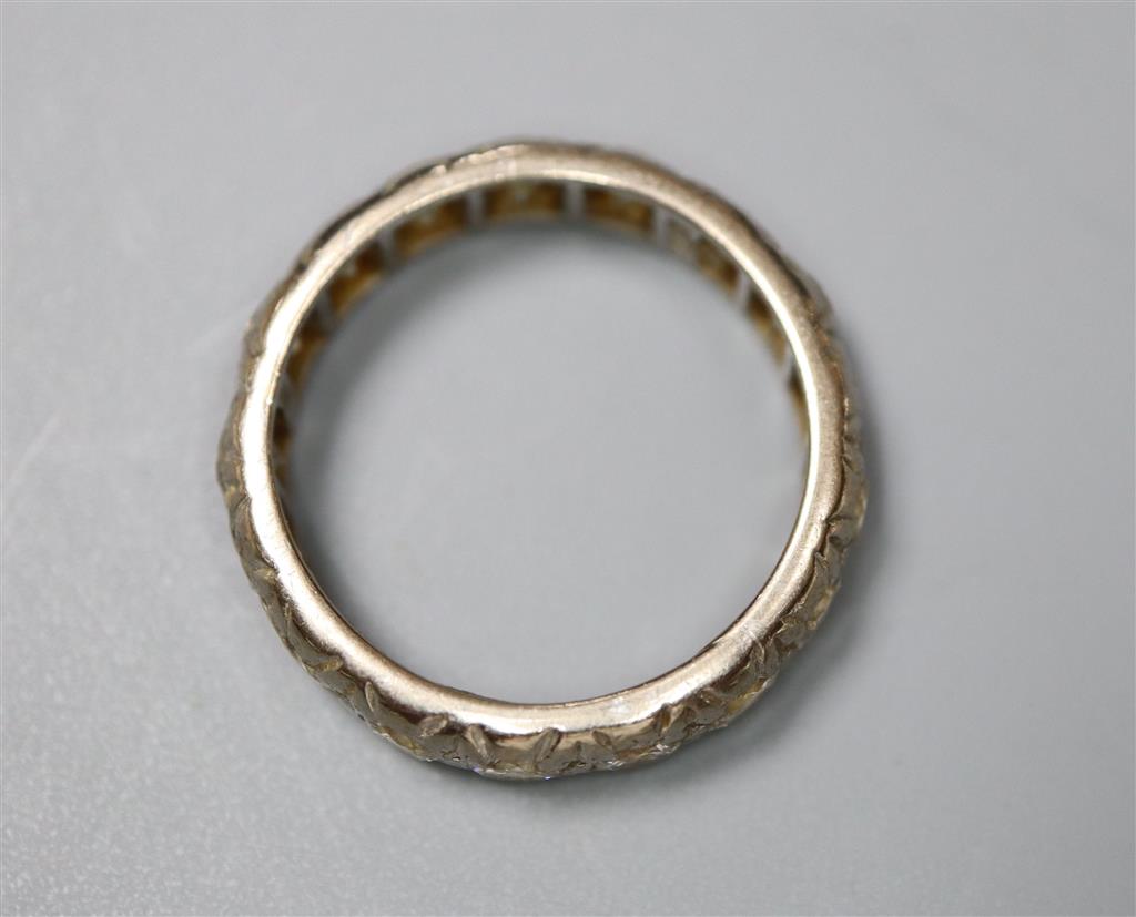 An 18ct white metal and diamond set full eternity ring, size N/O, gross 5.1 grams.